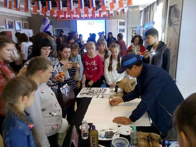 王文举老师为俄罗斯小朋友现场示范冰雪画,展示中国冰雪画的艺术魅力